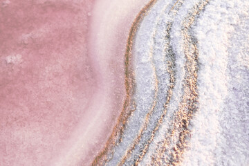Texture of the pink salt. Background of the pink lake. Close up of pink salt crystals.