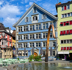 Fototapeta na wymiar Fountain and colorful painted buildings in Munsterhof Square, Zurich, Switzerland