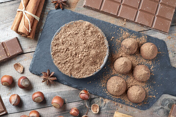 Different types of chocolate, cocoa powder, hazelnuts and other spices. Ingredients for making homemade truffles.