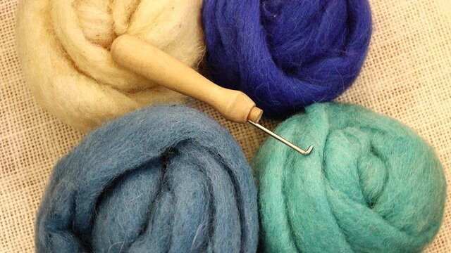 Wool of different colors for felting, felting needle, needlework