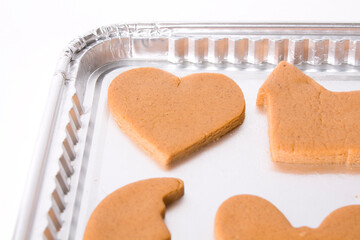 Raw gingerbread cookies on a pan ready for cooking