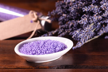 Obraz na płótnie Canvas Lavender bath salt and dried flowers of lavender close up.