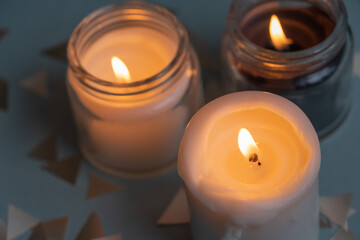 Fototapeta na wymiar Candles. Home interior decoration. Romantic candles. White and black wax. In glass jars