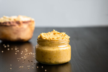 Homemade chickpea hummus and herbal healthy baked wheat vegan vegetarian cracker appetizer food savoury chip snack with black and white sesame and salt