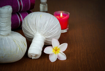 Spa composition with herbal compress ball for relaxation.beauty concept.wooden background.	