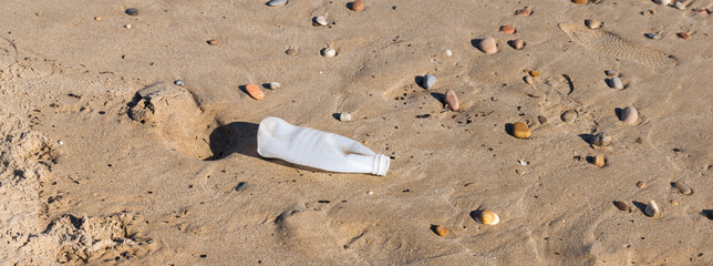 Plastic water bottle polluting the beach