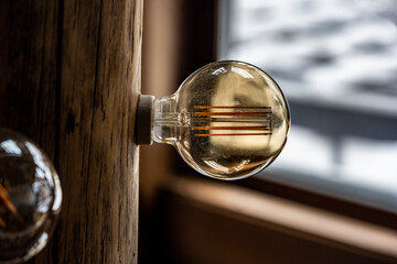vintage incandescent bulbs in the interior of a winter country house with wooden elements