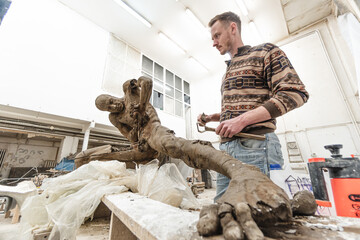 Sculptor in his workshop creating a sculpture