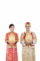Portrait of young couple in Tang suits holding Jin Dans