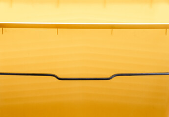 Abstract yellow background, photographed through a simple plastic bucket.
