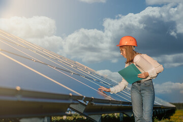 Businesswomen working on checking equipment at solar power plant with tablet checklist, woman working on outdoor at solar power plant