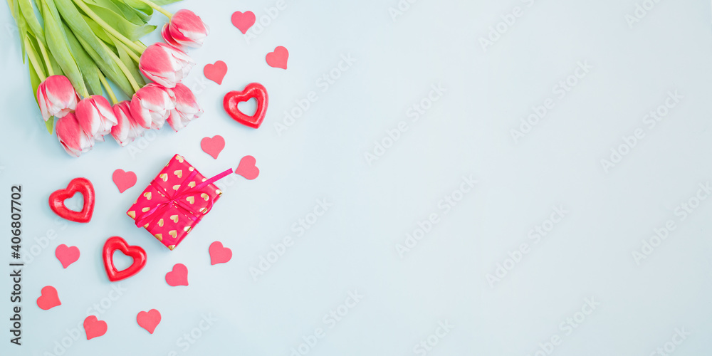 Wall mural flat lay valentines day frame with pink tulips and gift box on a light green background