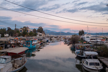 Fototapeta na wymiar Tolo, Peloponesse, Greece - January 06, 2019: Fishing boats under the sunset