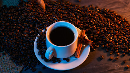 white cup of espresso coffee, roasted coffee beans. Dark background with neon popular trend lighting