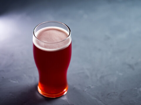 Glass Of Red Beer Ale On A Concrete Gray Table And Copy Space