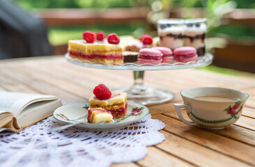 Cup of coffee and desserts on table, close-up.
