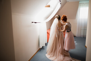 Hands of bridesmaids on bridal dress. Happy marriage and bride at wedding day concept
