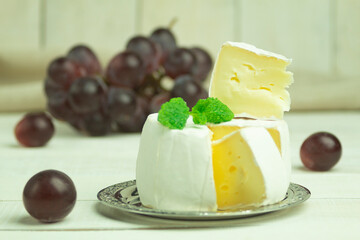 Camembert cheese cut into wedges with space for text
