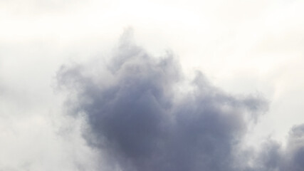 Fototapeta na wymiar Dark cloud on a background of light sky