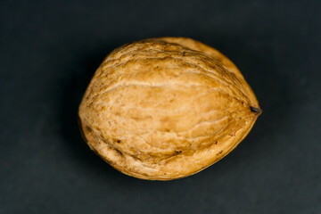 Small walnut on black background.