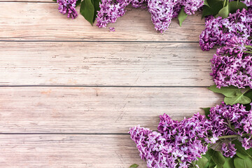 Lilac flowers on rustic wooden background. Top view, flat lay, copy space. Spring concept.