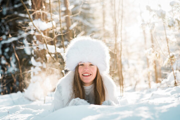 Fototapeta na wymiar Portrait of young woman in the frosty winter forest