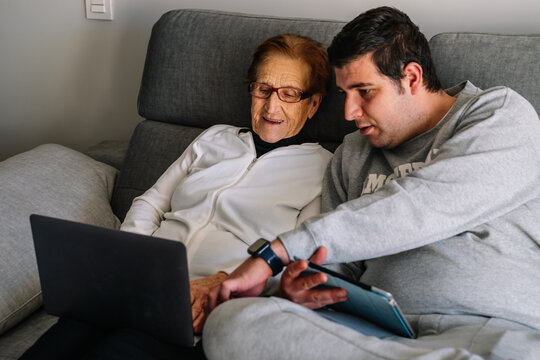 Young Boy With His Grandmother Teaching Her How To Use The Computer