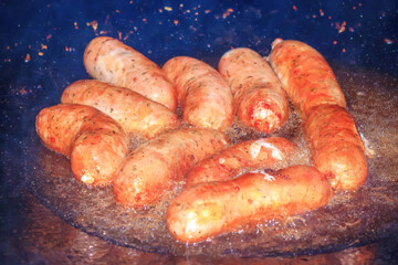 Grilled sausages on a fire