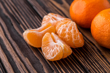 Mandarine orange or tangerine on wooden board