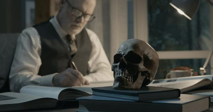 Academic professor studying a human skull