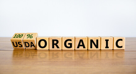 100 percent organic symbol. Fliped wooden cubes and changed words USDA organic to 100 percent organic. Beautiful white background, copy space. Business, healthy lifestyle organic concept.