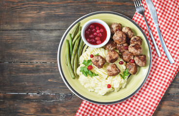 Swedish meatballs with mashed potatoes and green beans.