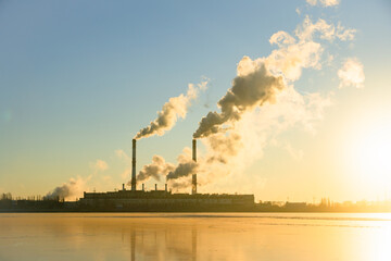 Factory pipe polluting air against sunset, environmental problems, smoke from chimneys