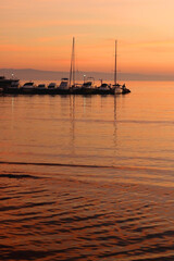 Dock with various small boats and beautiful sunset. Landscape in Split, Croatia.