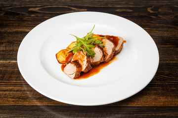 Juicy piece of grilled meat with fried potatoes and arugula