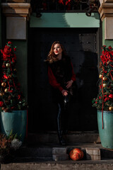 Elegant girl walk in a winter city. Beautiful lady with blond hair. Portrait of beautiful blond woman. Urban style concept. A woman wears puffer jacket with hood, black pants, and boots. © ibilyk13