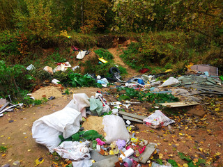 Unfocused background, large heaps of garbage along the road