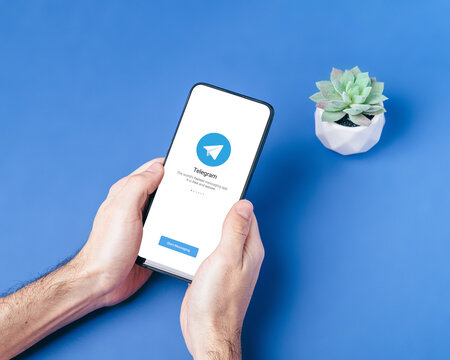 Melitopol, Ukraine - January 18 2021: Telegram application icon on smartphone screen. Online secure social media network. Blue background