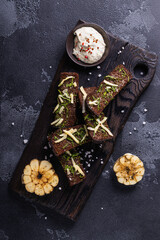 Black bread toasts with garlic and salt. Black garlic bread snack.