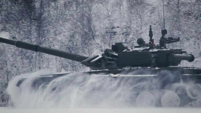 The tank moves at high speed along the snow field. Shooting range