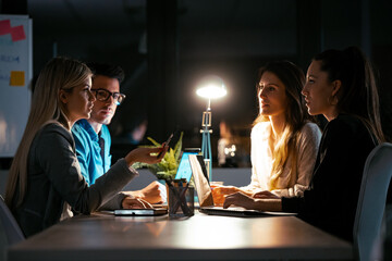 Smart business people working while talking on the desk in the coworking space in the office.