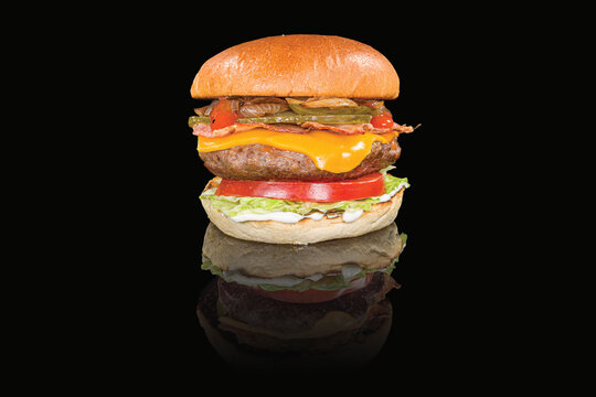 Delicious chicken cheeseburger with lettuce and sauce with reflection