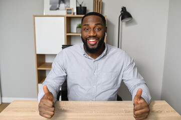 An African American young man looks into webcam and talking online, video call, virtual conference....