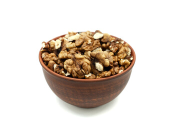 Peeled walnuts in a clay plate. Close-up. Isolated on white.