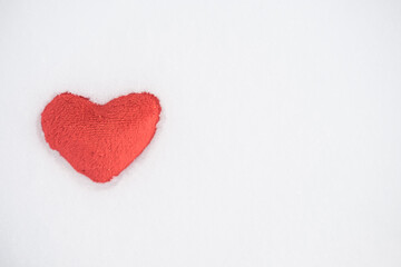 Tissue red heart lying in snow. love. valentine day