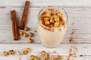 Traditional Turkish Boza, a fermented wheat and corn based drink popular in middle eastern countries in winter season. It is served with cinnamon and Turkish Leblebi (roasted chickpeas).