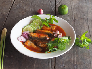 Sardines with Tomato Sauce in White Dish on Wooden Background