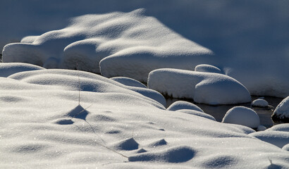 Abstract Art of nature - snow covered stones in river