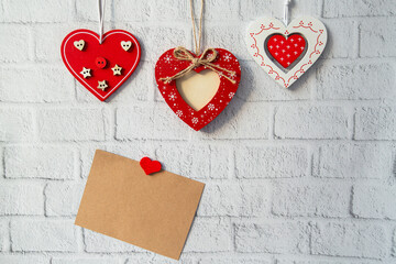 decorative red valentine and craft card for text on white brick background. valentines day concept
