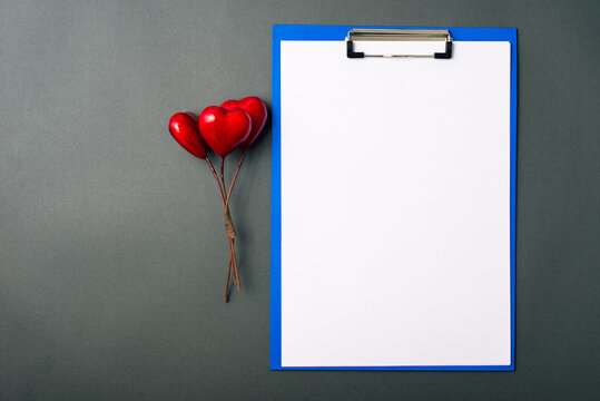 Photo of red hearts shape and blank paper, medicinal concept.